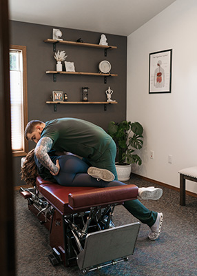 Chiropractor Olympia WA Nicholaus Martin Adjusting Patients Low Back